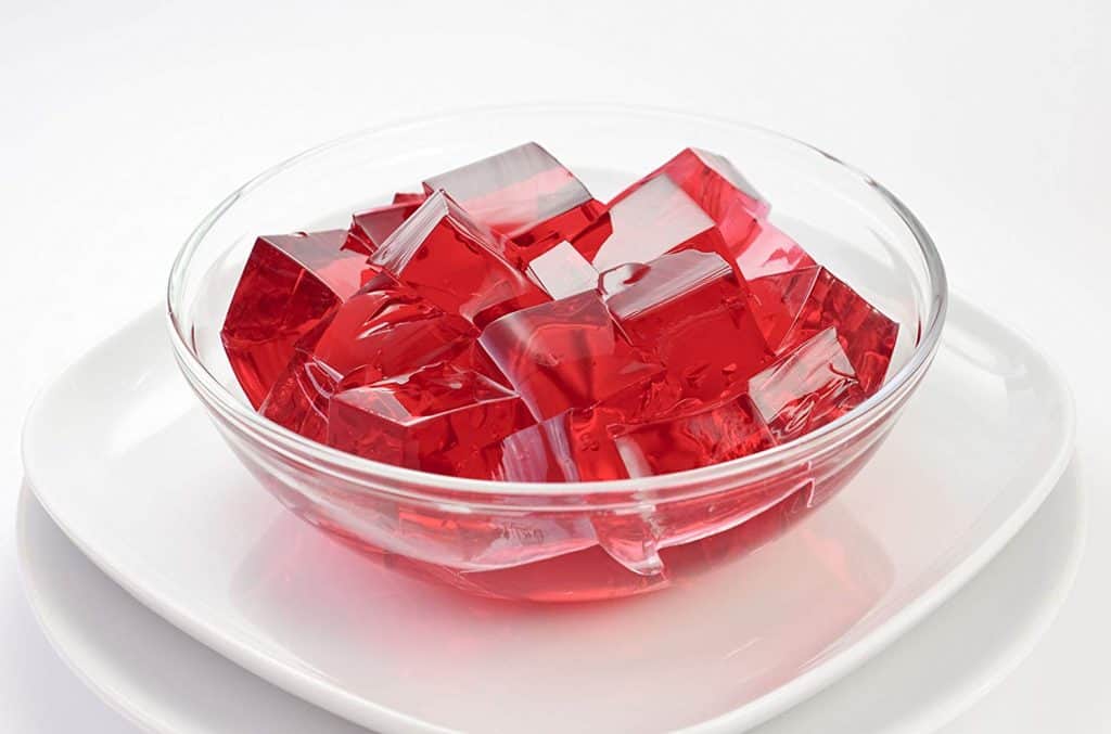 Red jello on white plate.