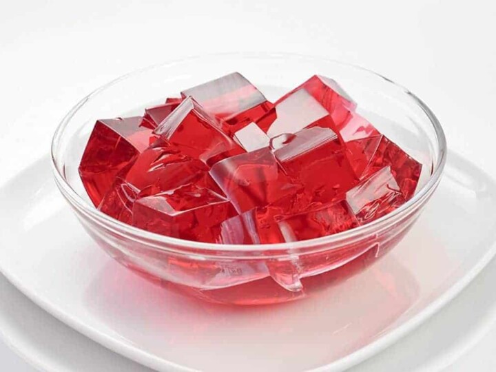 Red jello on white plate.