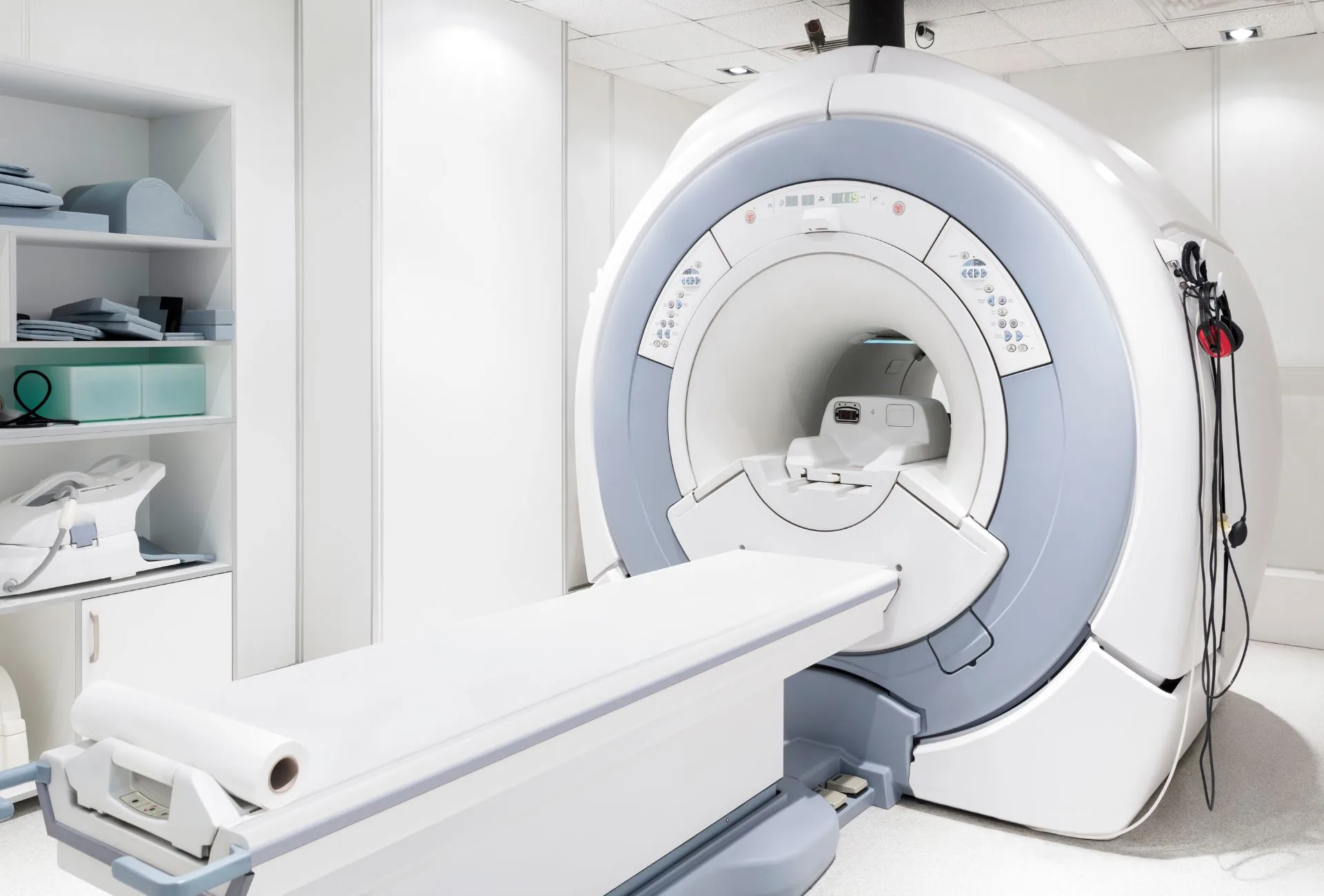 MRI machine in a clean room with white walls.